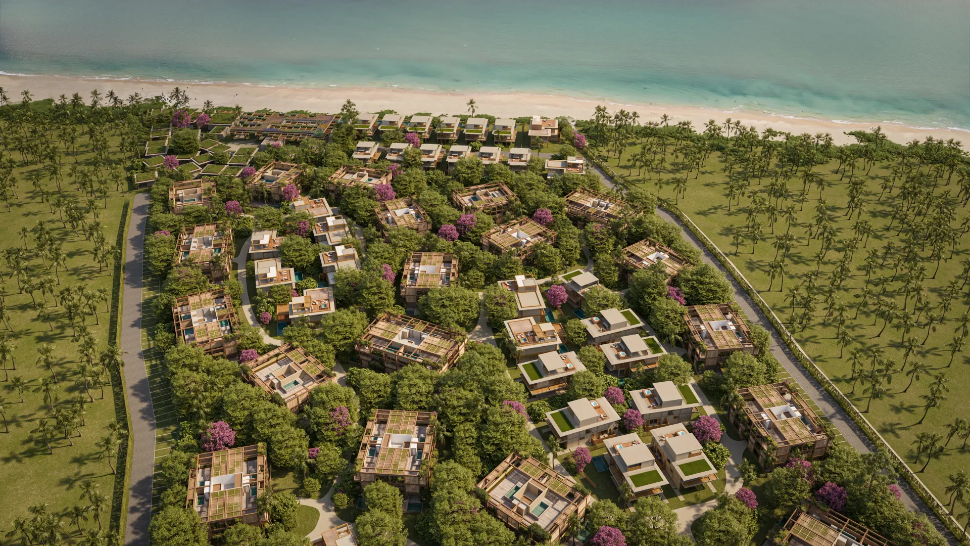 Vista aérea de resort com vilas entre vegetação tropical e árvores floridas próximo à praia